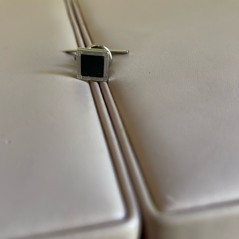 Silver and onyx tie holder.